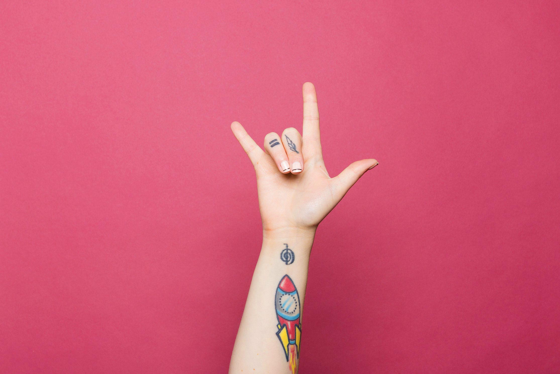 A photo of a tattooed hand, giving the